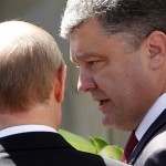 Poroshenko talks to Putin after a group photo  in Benouville