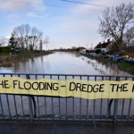 Floods defences : A banner asking for a return to dredging rivers to reduce the threat of flooding