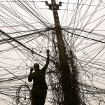 An Iraqi electrician checks the wires leading to a block of flats and all connected to a generator